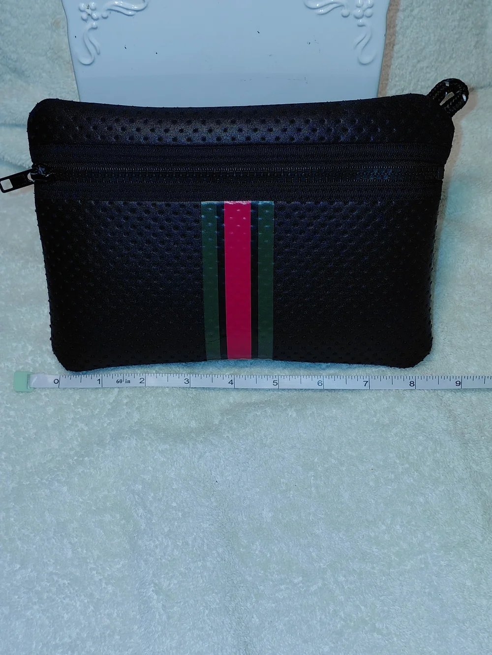 New perforated black leatherBlack Perforated Zip Pouch with Green and Red Stripe